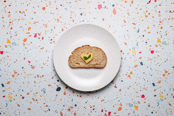 Heart-Shaped Hummus on Whole Wheat Bread Slice Held on White Plate
