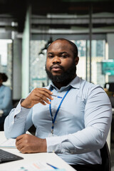 Equity analyst in office examining company earnings reports to forecast stock performance. Prop...