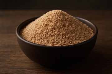 A close-up of a bowl filled with natural dietary fiber on a wooden table, captured in warm, soft lighting.