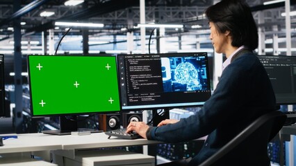 Data center admin typing on isolated screen PC keyboard, using AI. IT specialist at work using artificial intelligence on chroma key computer to oversee servers powering deep learning, camera A