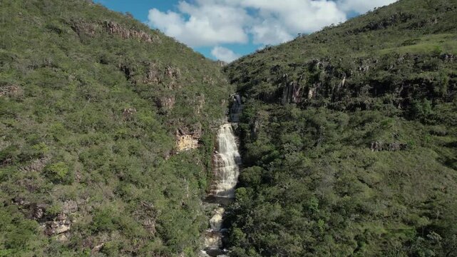 panoramic aerial view of waterfalls in Chapada dos Veadeiros, Vale do Macaco, large river with incredible large waterfalls, sunny day, trees, crystal clear water, Brazilian landscape