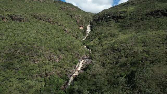 panoramic aerial view of waterfalls in Chapada dos Veadeiros, Vale do Macaco, waterfall, large river with incredible large waterfalls, sunny day, trees, crystal clear water, Brazilian landscape