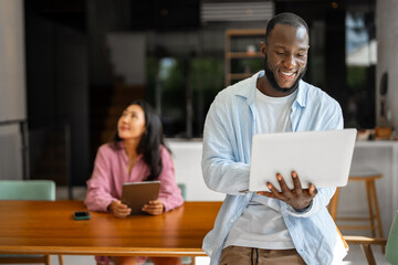 Remote work and digital business. Diverse couple collaborating online, managing projects with laptop