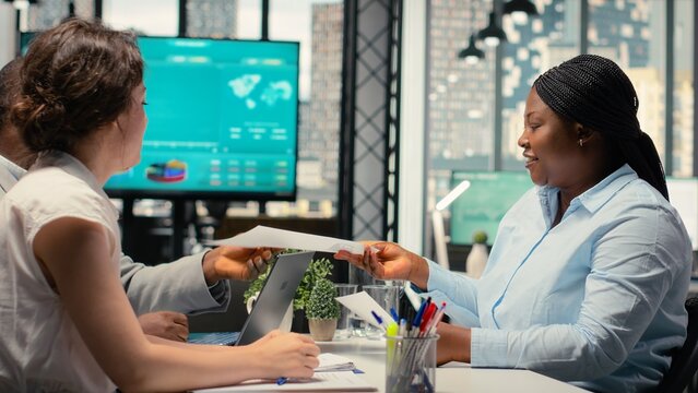 Female applicant and hiring staff greeting each other in interview meeting, asking questions and discussing about career opportunity for onboarding into the department. Head hunting.