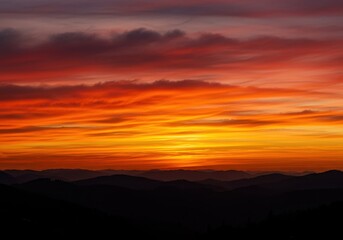 Spectacular vibrant cloudscape painted with warm hues of orange, red, and yellow creating a tranquil, dramatic twilight backdrop ,afterglow ,serene ,clouds