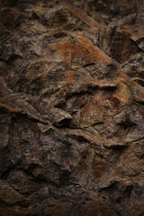 Black dark red orange brown rock texture with cracks. Close-up. Rough mountain surface. Stone granite background for design. Nature.	