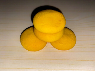 Four nastar with pineapple jam isolated on wooden pattern background. Delicious Snack.
