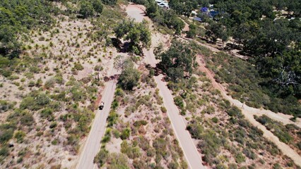 Scenic winding road through a lush landscape in the countryside during a sunny day