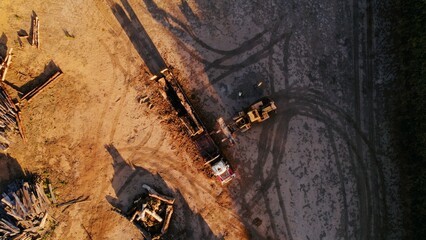 Construction site with heavy machinery in action during sunset hours creating new building...