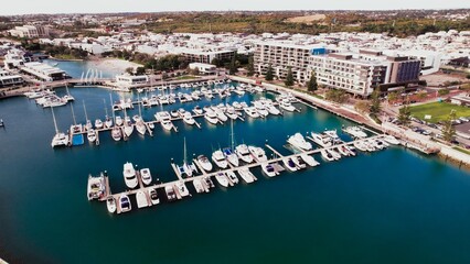 Scenic marina view showcasing yachts and surrounding buildings during a sunny day in a coastal town