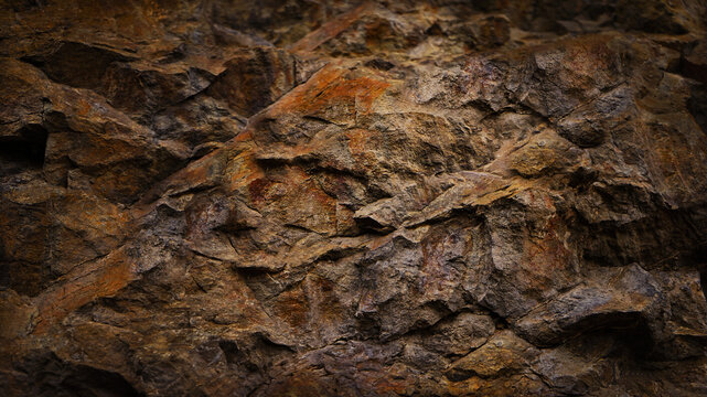 Black dark red orange brown rock texture with cracks. Close-up. Rough mountain surface. Stone granite background for design. Nature.	