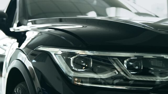 A stylish car is prominently displayed in an auto salon, showcasing appealing features for people interested in leasing. The sleek design and advanced technology attract attention.