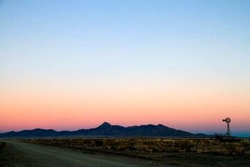 Sunset Road with Windmill and Mountains in Southern New Mexico — Classic Southwest Landscape