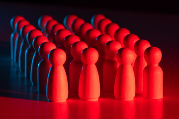 Organized crowd concept with red wooden figures arranged in rows, symbolizing leadership,...
