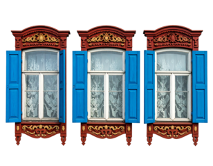 Three ornate, colorful, open, wooden windows with blue shutters against a black backdrop showcase intricate carvings