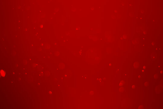 blurred red glitter vintage lights background. red bokeh shiny on dark background.
