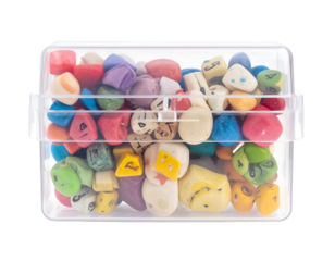 Transparent box filled with colorful, oddly shaped dice with numbers and spots visible inside against a white backdrop