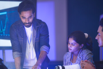 A startup team discusses future technology and innovation. They are analyzing data for a new AI robotics solution, planning for digital transformation and sustainable ESG goals.