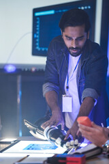 An Indian engineer in an RD lab tests an AI-powered prosthetic arm. The bionic hand has glowing...