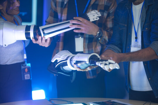 A startup team develops future medical technology. The diverse engineers test a new AI robotic prosthetic, an innovative solution for healthcare and digital transformation.