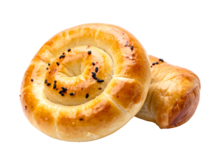 Two golden, spiraled pastries topped with black seeds against a transparent background