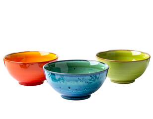 Trio of vibrant ceramic bowls, colored orange, blue, and green, arranged against a black background