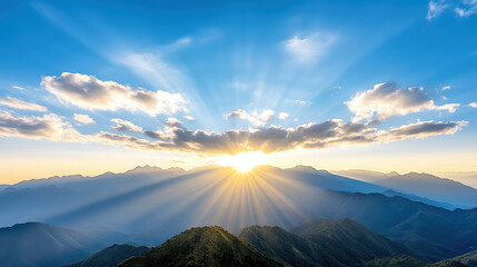 Breathtaking sunrise over mountain range with rays of light shining through clouds