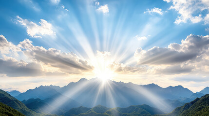 Bright sun rays illuminate mountain peaks blue sky with soft clouds, creating serene atmosphere