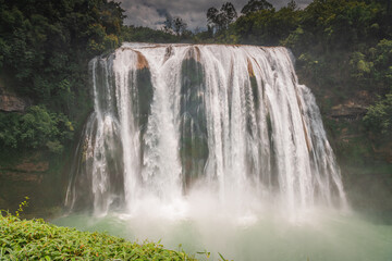 China Guizhou Huangguoshu Waterfall in Summer. It is one of the largest waterfalls in China and East Asia, classified as a AAAAA scenic area by the China National Tourism Administration.