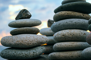 Towers of gray stones in close-up against sunset and sky