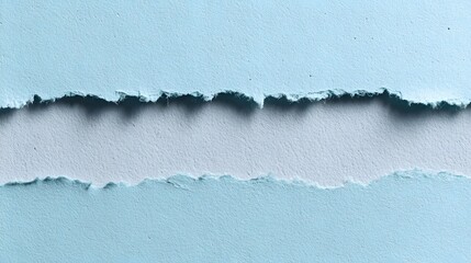 Two strips of light blue textured paper reveal a paler surface underneath with rough torn edges
