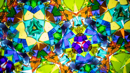 Stunning macro photograph of a natural kaleidoscope pattern showcasing vibrant colors, geometric design, and light reflections, shot with a camera.