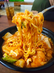 Close Up Shot of Spicy Indonesian Seblak Noodles with Savory Chicken Egg Topping