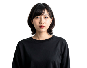 Young woman with dark bob haircut and black top poses against a black background, eyes forward