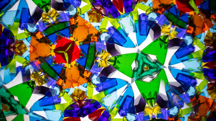 Stunning macro photograph of a natural kaleidoscope pattern showcasing vibrant colors, geometric design, and light reflections, shot with a camera.