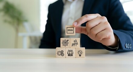 Businessman stacking wooden blocks with business icons symbolizing growth strategy and career development success