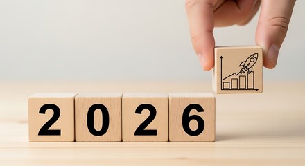 Hand placing wooden block with rocket launching above graph symbolizing growth and success in the year 2026