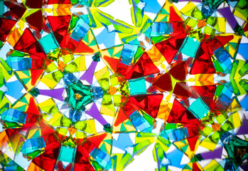 Stunning macro photograph of a natural kaleidoscope pattern showcasing vibrant colors, geometric design, and light reflections, shot with a camera.