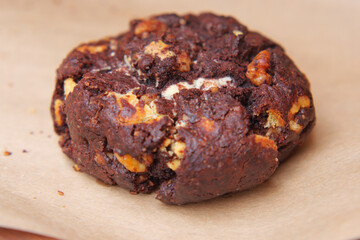 Freshly baked chocolate cookie on brown paper
