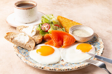 Fried eggs with salmon and toast on a plate.