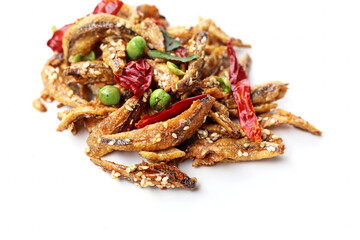 Crispy fried anchovies with sesame, dried chili, green peas, and herbs on white background.