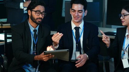 Multicultural business and IT professionals collaborating on digital devices, analyzing data, and discussing strategy in a modern tech office. Concepts of teamwork, innovation, and global  - Powered by Adobe