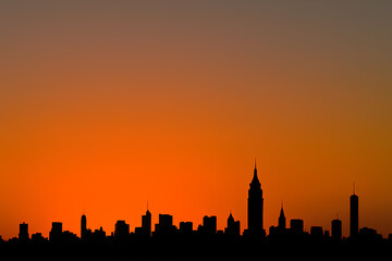 Fototapeta premium City Skyline Silhouette at Sunset with Vibrant Orange Sky, Urban Horizon Background, Copy Space