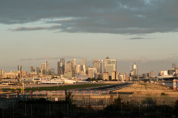 Fototapeta premium London city airport with canary wharf cityscape at sunset