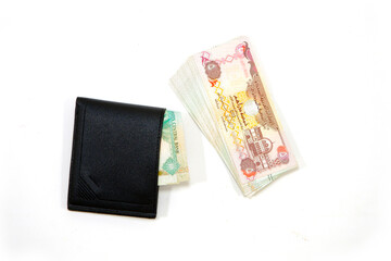 Currency notes with black wallet together on white background close-up view 