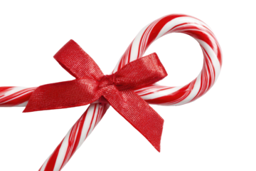 Sweet candy canes crossed, tied with a bright red bow on black