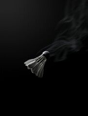 Dramatic Badminton Shuttlecock with Smoke Effect on Dark Background for Sports and Conceptual Imagery