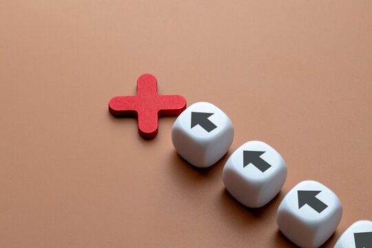 A single red X sign interrupts a line of white dice with black arrows. Mistake, cancellation, failure, wrong direction, or the stopping of an action or plan concept.