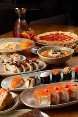Rolls, pizza and pasta on the table.