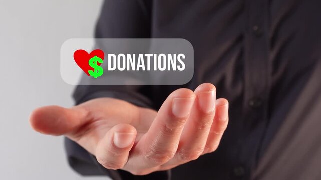 Close-up of a hand holding a donation button with a heart and a money sign